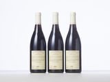 three bottles of wine sitting on top of a table