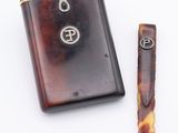 a lighter and a lighter case sitting next to each other