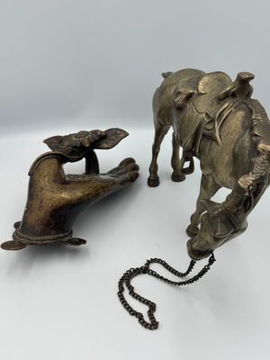 a statue of an elephant and a dog on a chain