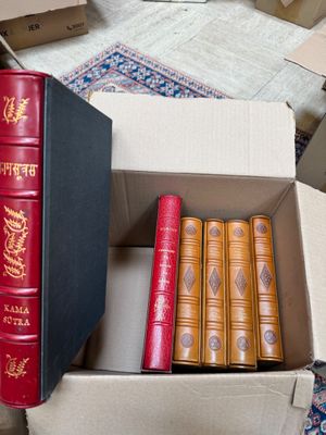 a lot of books that are in a box on the floor