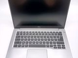 an open laptop computer sitting on top of a white table