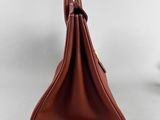 the back view of a brown leather purse with a gold clasp