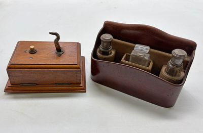 a small wooden box with bottles in it on a table