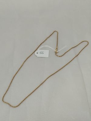 a gold chain necklace with a tag on it