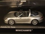 a silver toy car in a box on a table