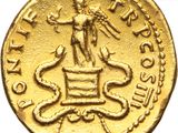 a close up of a gold coin with a statue on top of it