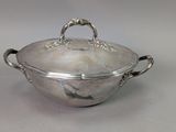 an antique silver plated casserole with handles and handles