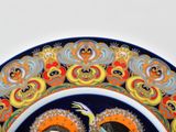 a decorative plate with two birds on it