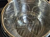 a silver bowl on a stove with a box in the background