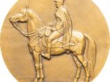 une image représentant une médaille de bronze sur laquelle figure un homme à cheval