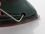 a person using a sander on a white surface