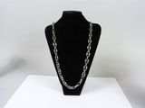 a close up of a necklace on a mannequin on a table
