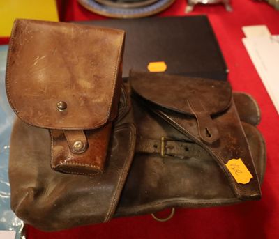 a brown bag sitting on top of a table next to a laptop