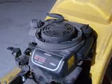 a yellow lawn mower that is sitting in the garage