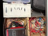 a drawer full of electronics and wires in a room