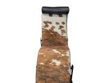 brown and white cowhide recliner chair with black leather seat