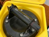 a yellow box with a black handle on top of it