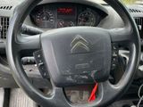 the interior of a car with a steering wheel and dashboard controls