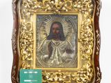 an old picture of jesus in a gold frame on a white wall