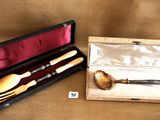 a box with a knife, spoon, and spoon rest in it