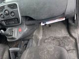 a dirty car dashboard with a steering wheel and dashboard controls
