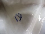 a close up view of a porcelain figurine of a cat