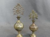 pair of antique brass vases on a grey background