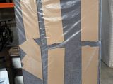 a large piece of cardboard sitting on the floor in a warehouse