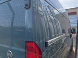 a blue van that is parked in a parking lot