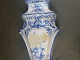 a blue and white vase with a bird on it