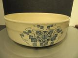 a white bowl with blue designs on it sitting on a table