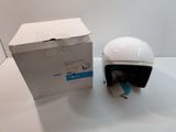 a white helmet sitting next to a box on a table