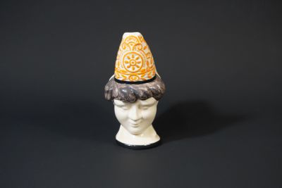 a close up of a figurine with a hat on it ' s head