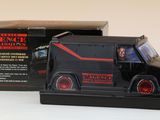 un camion miniature posé devant une boîte