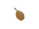 a small piece of gold on a white surface