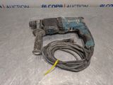a close up of a corded drill with a cord attached to it