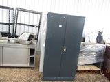 a metal cabinet in the middle of a pile of other items