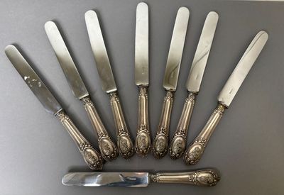 six knives and a knife holder on a table