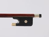 a violin bow on a white surface with a white background