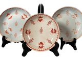 three plates that are sitting on a stand