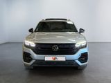 the front of a silver volkswagen suv parked in a showroom