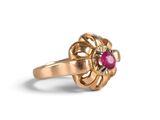 an image of a gold ring with a ruby stone in the center