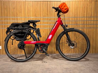 a red bike parked in front of a wooden wall