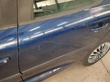 a blue car that is parked in a garage