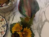 a table with a bowl of cookies and a basket of sunflowers on it
