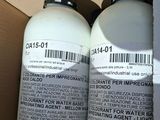 three bottles of water sitting in a cardboard box