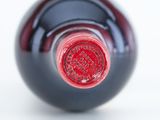 a close up of a wine bottle with a red label