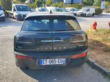 a small black car parked on the side of the road