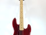an electric bass guitar on a stand against a white background