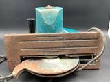 a blue candle sitting on top of a table next to a piece of wood